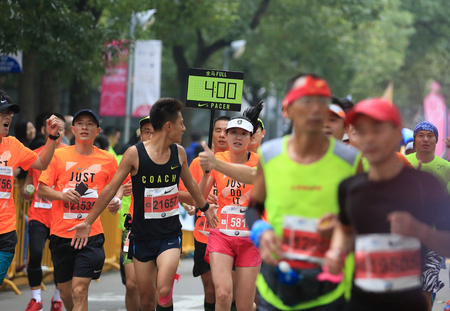 SHANGHAI,CHINA - NOVEMBER 08:Marathon runners running on city road at the 20th Shanghai Marathon NOVEMBER 08,2015 in Shanghai,Chinaのeditorial素材