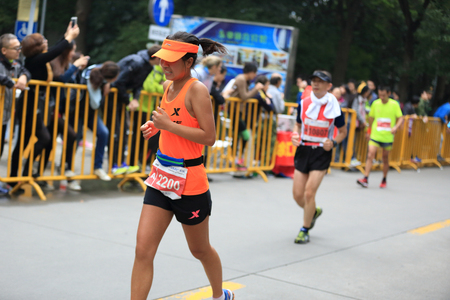 SHANGHAI,CHINA - NOVEMBER 08:Marathon runners running on city road at the 20th Shanghai Marathon NOVEMBER 08,2015 in Shanghai,Chinaのeditorial素材