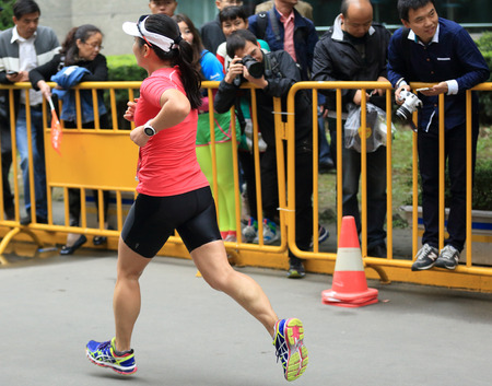 SHANGHAI,CHINA - NOVEMBER 08:Marathon runner running on city road at the 20th Shanghai Marathon NOVEMBER 08,2015 in Shanghai,Chinaのeditorial素材