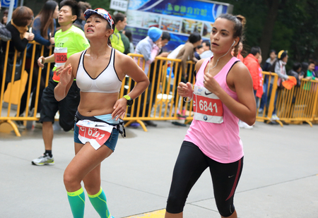 SHANGHAI,CHINA - NOVEMBER 08:Marathon runners running on city road at the 20th Shanghai Marathon NOVEMBER 08,2015 in Shanghai,Chinaのeditorial素材