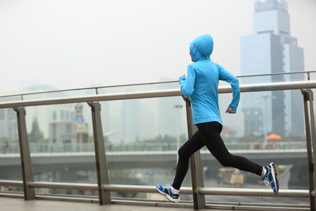 young fitness woman runner running at shanghai cityの写真素材