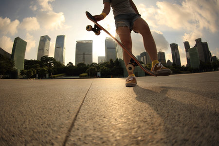 skateboarder skateboarding at sunrise cityの写真素材
