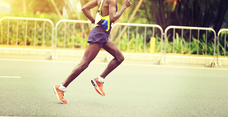 Marathon runner running on city roadの写真素材