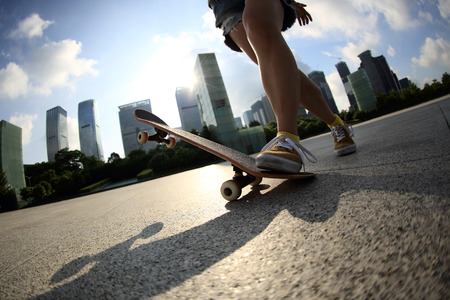 skateboarder skateboarding at sunrise cityの写真素材