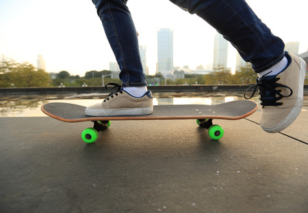 skateboarder skateboarding at cityの写真素材