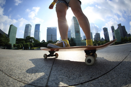 skateboarder skateboarding at sunrise cityの写真素材