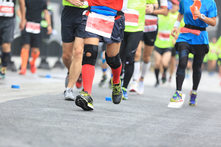 Marathon running race, people feet on city roadの写真素材
