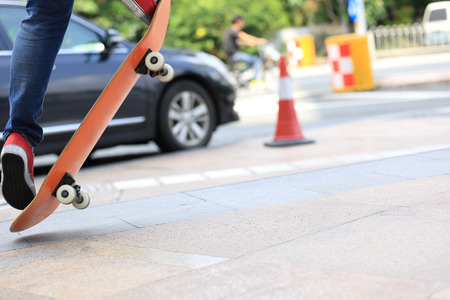 young skateboarder skateboarding on cityの写真素材