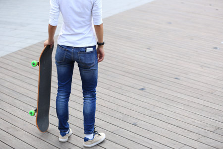 young woman skateboarder with skateboardの写真素材