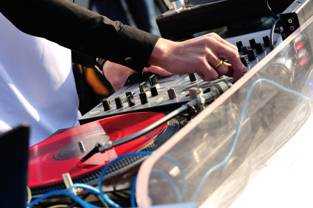 dj hands with the audio mixer
