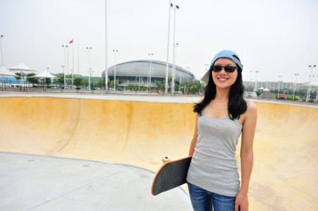 skateboarder walking at skateparkの写真素材