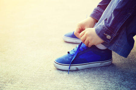 skateboarder hands tying shoelaceの写真素材