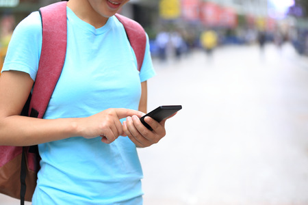 young woman use cellphone on streetの写真素材