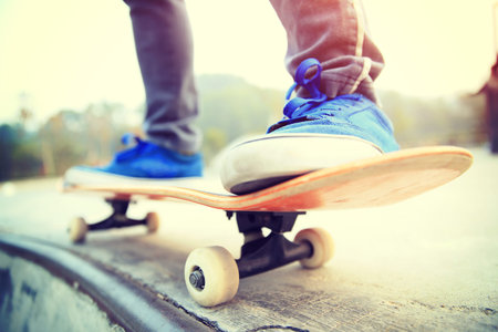 skateboarder legs skateboarding at skatepark ramp