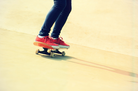 skateboarding legs riding on a skateboardの写真素材