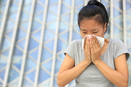 cough woman sneeze nose outdoorの写真素材