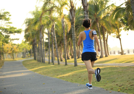 Runner athlete running at tropical park.  