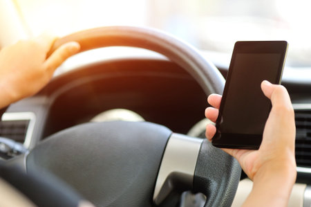 woman driver use her cell phone driving car