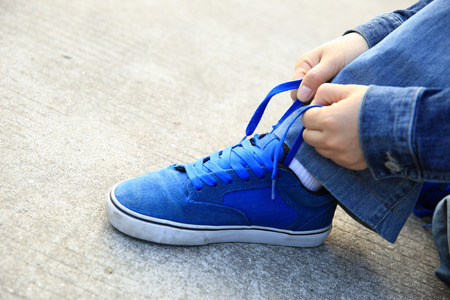 skateboarder hands tying shoelaceの写真素材