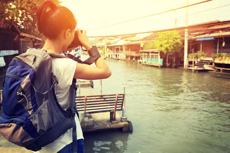 woman tourist taking photo at Damonen saduak floating marketの写真素材