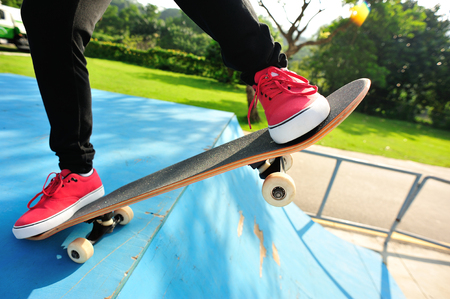 skateboarding woman at skateboard parkの写真素材