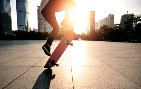 skateboarder legs skateboarding trick ollie at city skate parkの写真素材