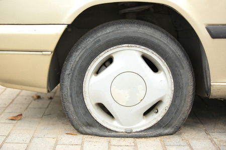 flat tyre on car wheelの写真素材
