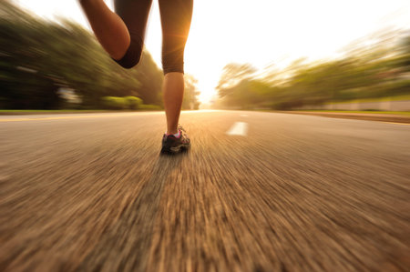 young fitness woman running at road.