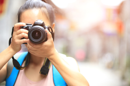woman photographer taking photo outdoorの写真素材