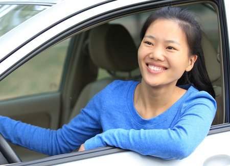 happy woman driver sitting in car