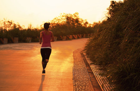 healthy asian woman runner running outdoor under sunrise