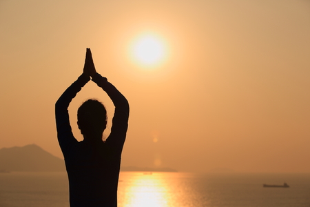 healthy yoga woman meditation at sunrise seasideの写真素材