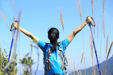 hiking woman enjoy the beautiful view at mountain peakの写真素材