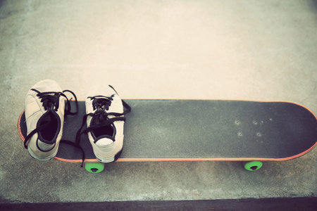 sneakers and skateboard at skatepark