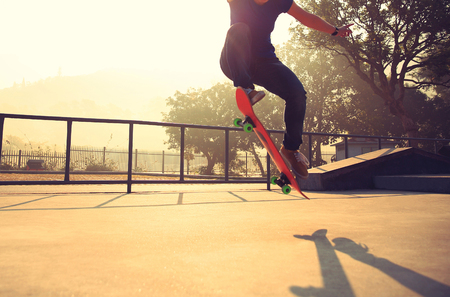 skateboarding woman at sunrise skateparkの写真素材