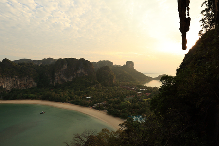 beautiful landscape with sunrise through the cliff at seasideの写真素材
