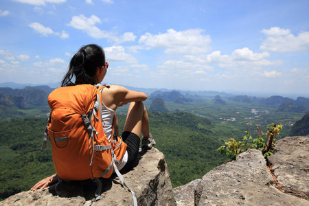 successful woman hiker enjoy the view on mountain topの写真素材