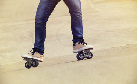 freeline skateboarder legs riding on freeline at skatepark