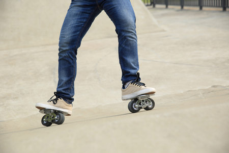 freeline skateboarder legs riding on freeline at skatepark