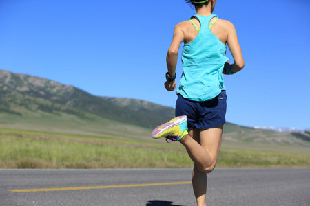 healthy lifestyle young fitness woman runner running on road