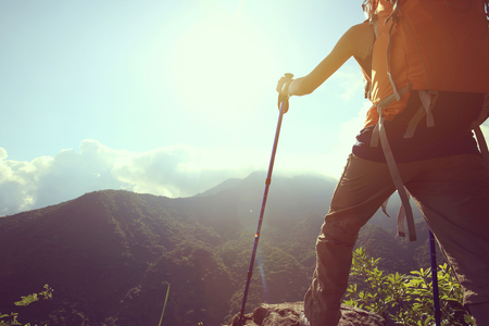 young woman backpacker enjoy the view on mountain peakの写真素材