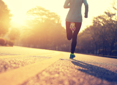 young fitness woman runner running on road