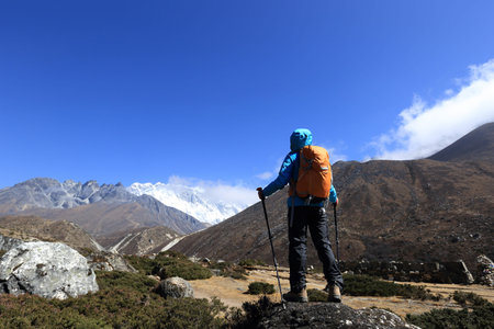young woman backpacker trekking on himalaya mountainsの写真素材
