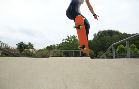 skateboarder legs doing a ollie trick at skateparkの写真素材