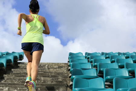healthy lifestyle young fitness woman running on stairsの写真素材