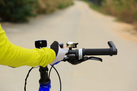 cyclist setting stopwatch before riding mountain bike on forest trailの写真素材