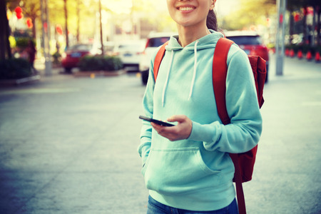 young asian woman use smartphone on cityの写真素材
