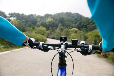 cyclist cycling mountain bike on forest trailの写真素材