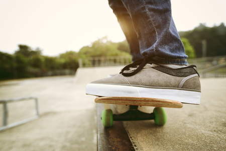 young skateboarder practicing at skate parkの写真素材