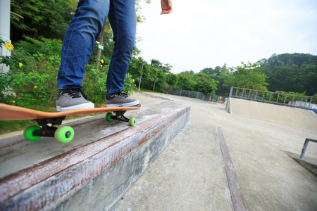 skateboarder legs riding skateboard at skateparkの写真素材
